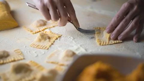 Closeup process making ravioli vegan homemade pasta. Housewife cook closes wi Stock Photos
