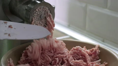 Closeup process of meat grinding in the kitchen with mincing machine Stock Footage 165058225