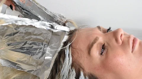 Closeup process of removing the foil from the head Stock Footage 124857175