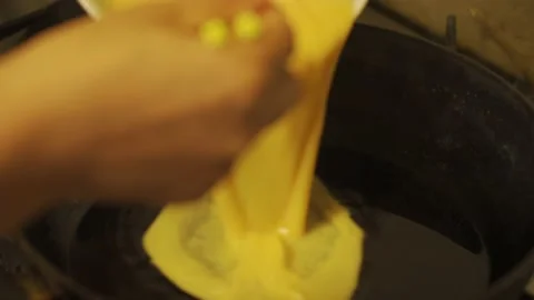 Closeup, process of scrambled egg, beaten egg poured into oil and stir fried Stock Footage 136516079
