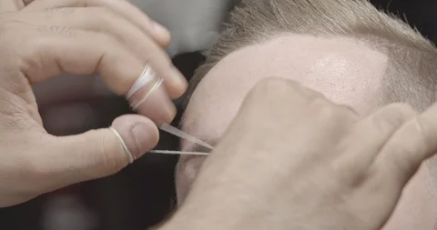 Closeup of process of threading procedure in barber shop. Slow motion. Stock Footage 103160110