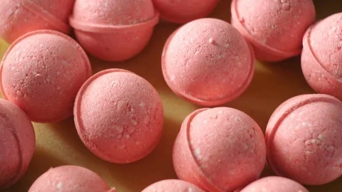 Closeup production of bath bombs in red color shot in the laboratory Stock Footage 108388217