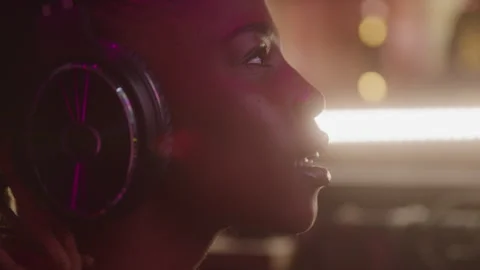 Closeup Profile of a Female Sound Engineer in Headphones Working in a Studio Stock-Footage 270318698