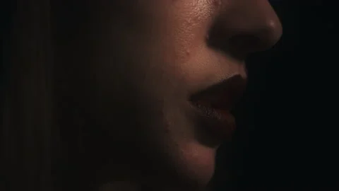 Closeup Profile of Meditating Woman's Face Mouth Chanting with Black Stock Footage 150751979