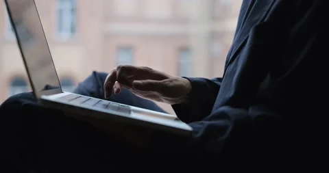 Closeup profile shot of female in business suit typing on laptop, 4K Stock Footage 239440407