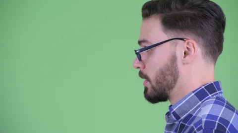 Closeup profile view of happy young bearded hipster man talking Stock Footage 114487666