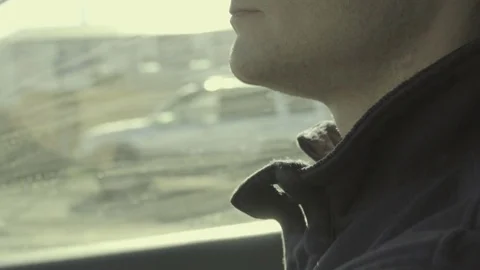 Closeup profile of young man driving car in slow motion Stock Footage 84969828