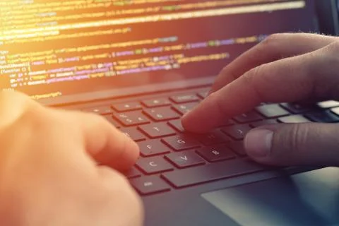 Closeup programmer coding on screen. Hands coding html and programming on laptop Foto stock