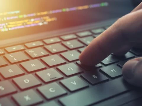 Closeup programmer coding on screen. Hands coding html and programming on lap Stock Photos