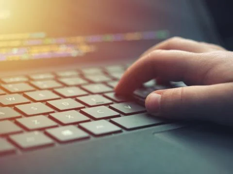 Closeup programmer coding on screen. Hands coding html and programming on lap Stock Photos