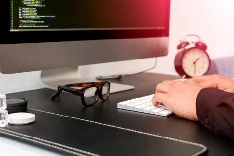Closeup of programmer hand on white keyboard while working Stock Photos