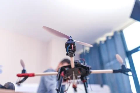 Closeup programmer hands making electronic FPV - first person view drone at h Stock Photos