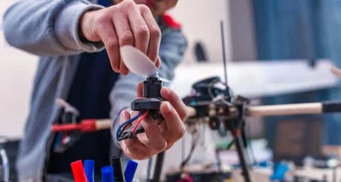 Closeup programmer hands making electronic FPV - first person view drone at h Stock Photos