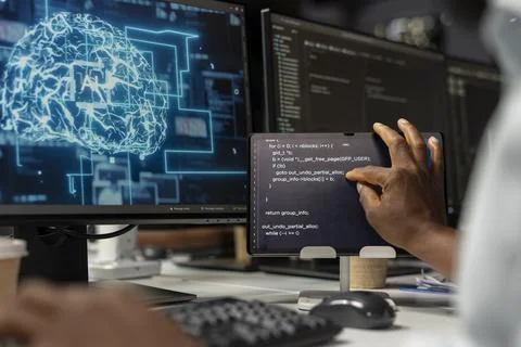 Closeup of programmer in office using tablet to automate repetitive task with AI Stock-Fotos