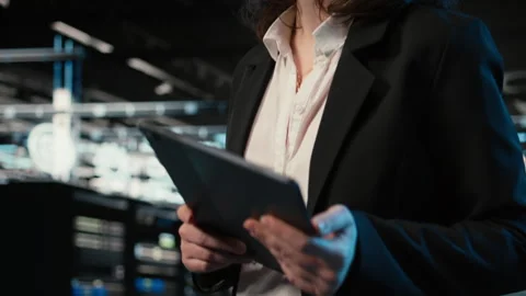 Closeup of programmer walking in data center, optimizing server load with tablet Video stock 328334586