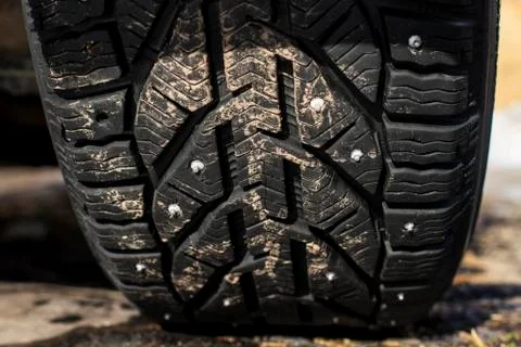 Closeup protector of used winter studded tires - wheel service Stock Photos