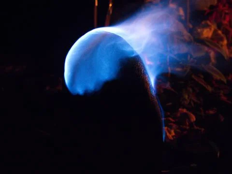 Closeup of psychedelic blue flame burning over rock in mandala Ecuador. Stock Photos