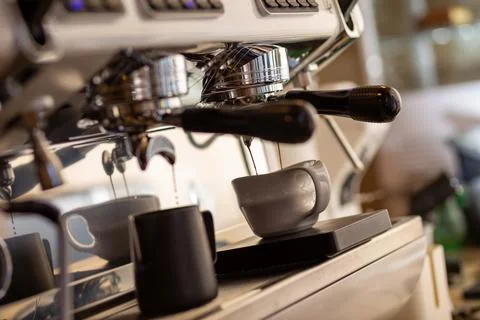 Closeup of pump driven espresso machine and portafilter brewing by forcing pr Stock Photos