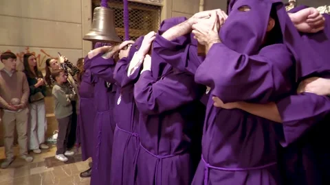 Closeup-of-purple-robed-procession-carriers-in-malaga-spain Stock Footage 335942558