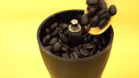 Closeup put coffee beans to hand grinder machine Stock Footage 108984355