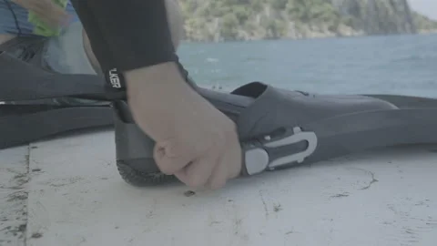 Closeup of the putting on of a scuba flipper Stock Footage 232308733