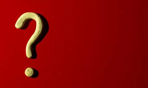Closeup question mark made of clay on red background Stock Photos
