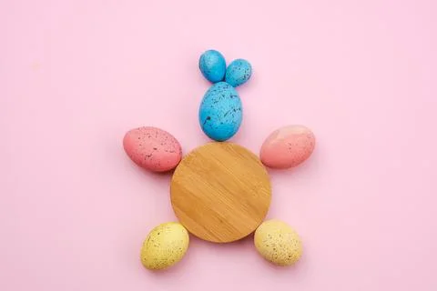 Closeup of a rabbit made of eggs and a wooden circle on the table. Easter c.. Stock Photos