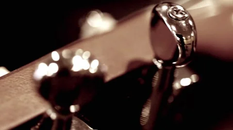 Closeup rack focus of guitar tuning Stock Footage