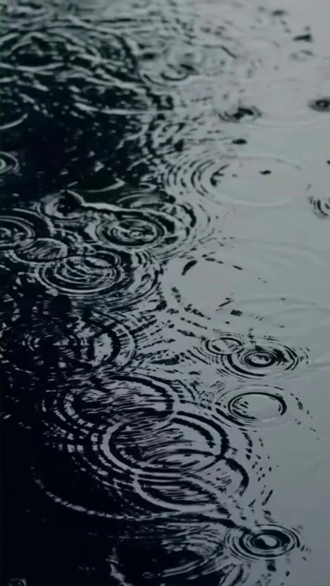 Closeup of rain drop splash into asphalt puddle creating ripple effect 스톡 동영상 342800195
