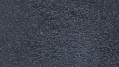 Closeup of rain hitting asphalt road constantly. Downpour. 4K Video stock 276397663