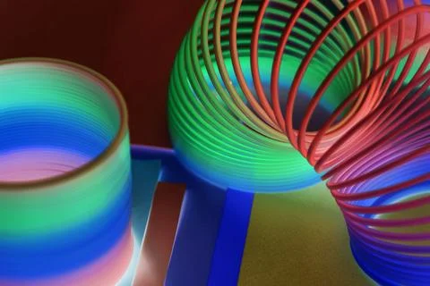 Closeup of rainbow spring toy background in a negative effect Stock Photos