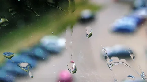 Closeup raindrops water droplets trickling down on wet window glass during rain Stock-Footage 201487555