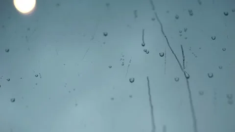 Closeup of raindrops on window glass surface Stock Footage 318677568