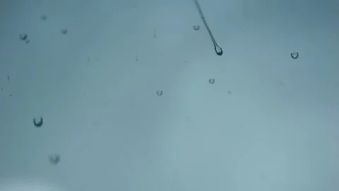 Closeup of raindrops on window glass surface Video stock 318677576