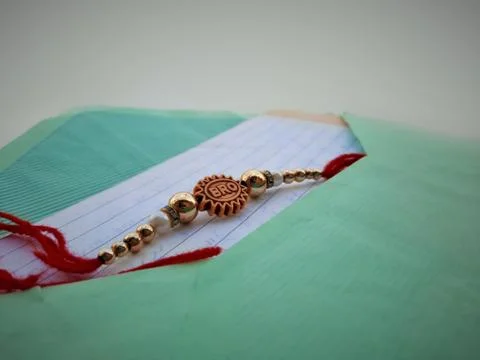 Closeup of Rakhee or holy thread with message in envelope on Raksha Bandhan Stock Photos