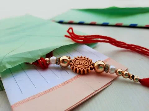 Closeup of Rakhee or holy thread with message in envelope on Raksha Bandhan Stock Photos