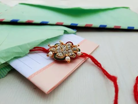 Closeup of Rakhee or holy thread with message in envelope on Raksha Bandhan Stock Photos