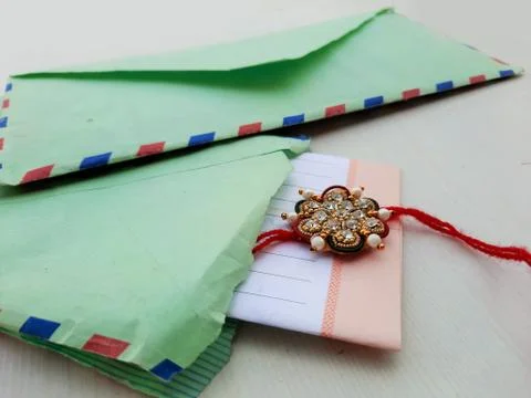 Closeup of Rakhee or holy thread with message in envelope on Raksha Bandhan Stock Photos