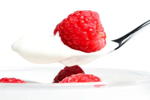 Closeup of a raspberry on a spoon with yogurt Stock-Fotos