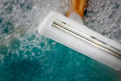 Closeup razor with bubble on blue tile background. Stock Photos