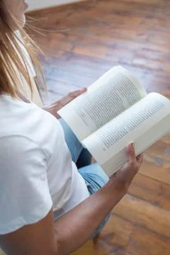 Closeup of a reader reading a book at home Stock Photos