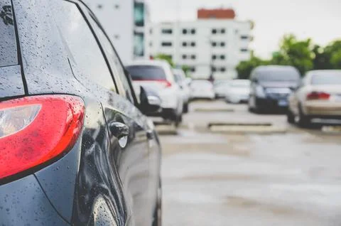 Closeup of rear or back side of car with cars parking. Stock Photos