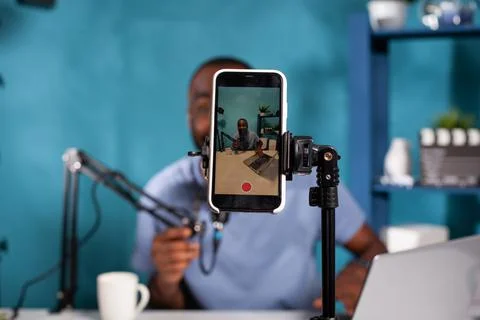 Closeup of recording smartphone filming content creator feeling joy after Stock Photos