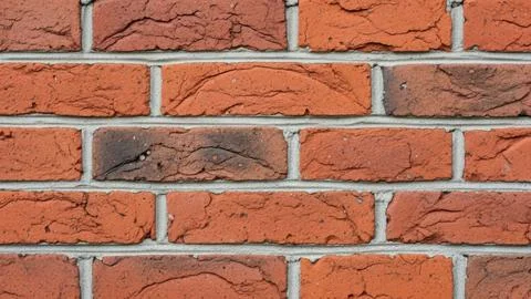 Closeup of a red brick wall with gray mortar Stock Photos