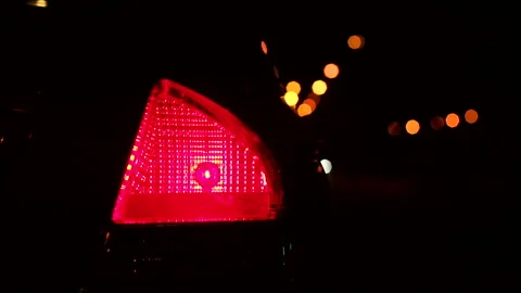 Closeup of red burning headlights Parking lights on the car at night in the dark Stockbeeldmateriaal 115251271
