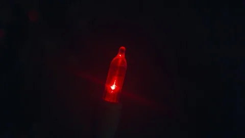 Closeup of a Red Christmas Light as it Blinks On and Off in 4k Stock Footage 98962856