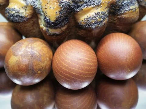 Closeup red eggs with marble pattern and Easter cake on mirror background Stock Photos