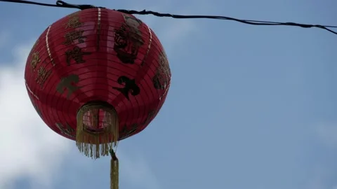 Closeup of red lantern at Chinese New Year celebration, blue sky background Stock Footage 134181540