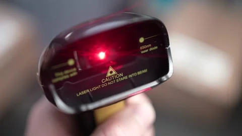 Closeup Red Laser of a Bar Code Scanner Flashing Stock Footage 185116620