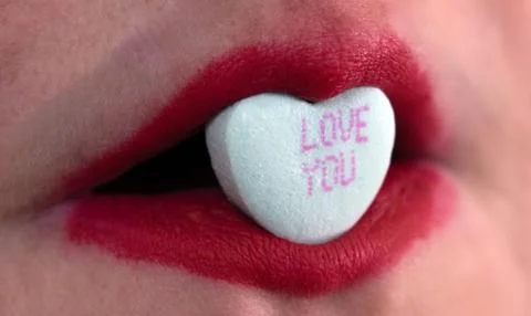 Closeup red lipstick with candy Stock Photos